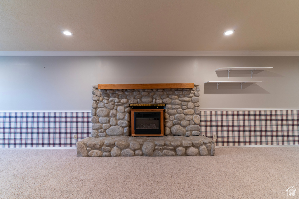 Unfurnished living room with crown molding, carpet, a fireplace, and recessed lighting