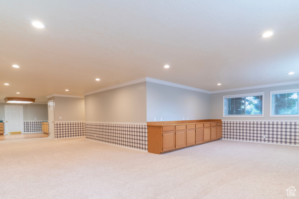 Unfurnished room featuring light carpet, recessed lighting, and ornamental molding
