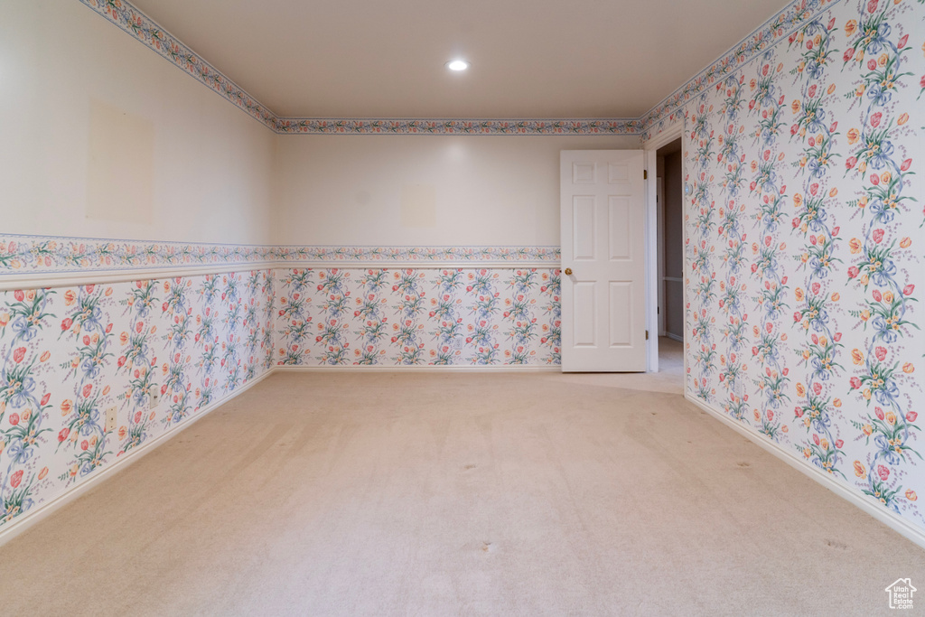 Spare room featuring carpet floors, recessed lighting, baseboards, and wallpapered walls