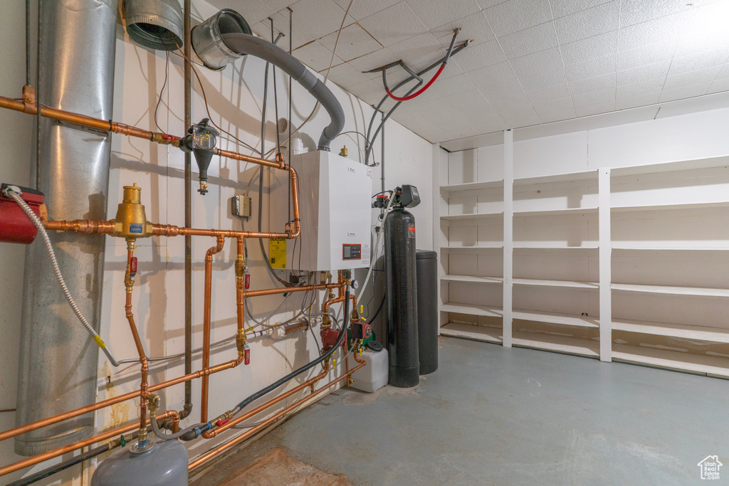 Utility room featuring tankless water heater