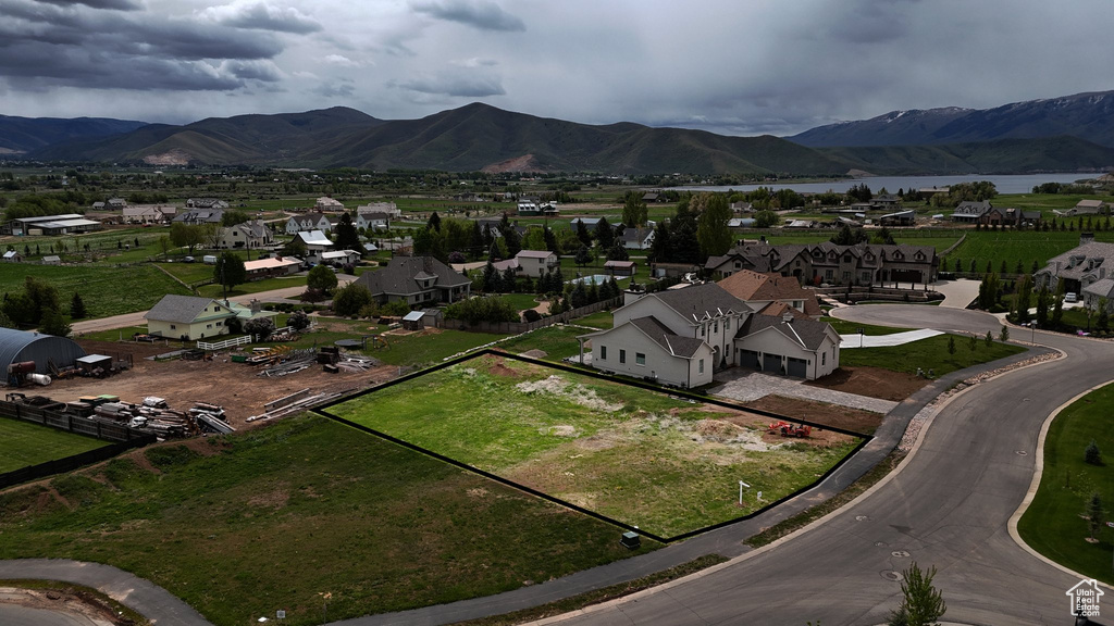 Aerial perspective of suburban area featuring a mountain backdrop and property boundaries highlighted