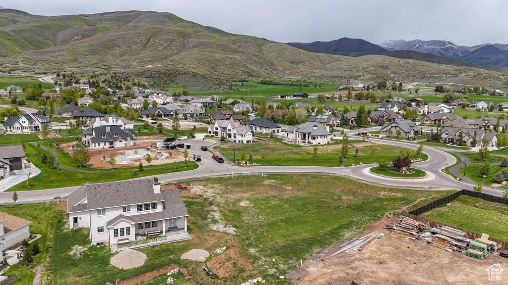 Aerial view of property's location with a mountainous background and nearby suburban area