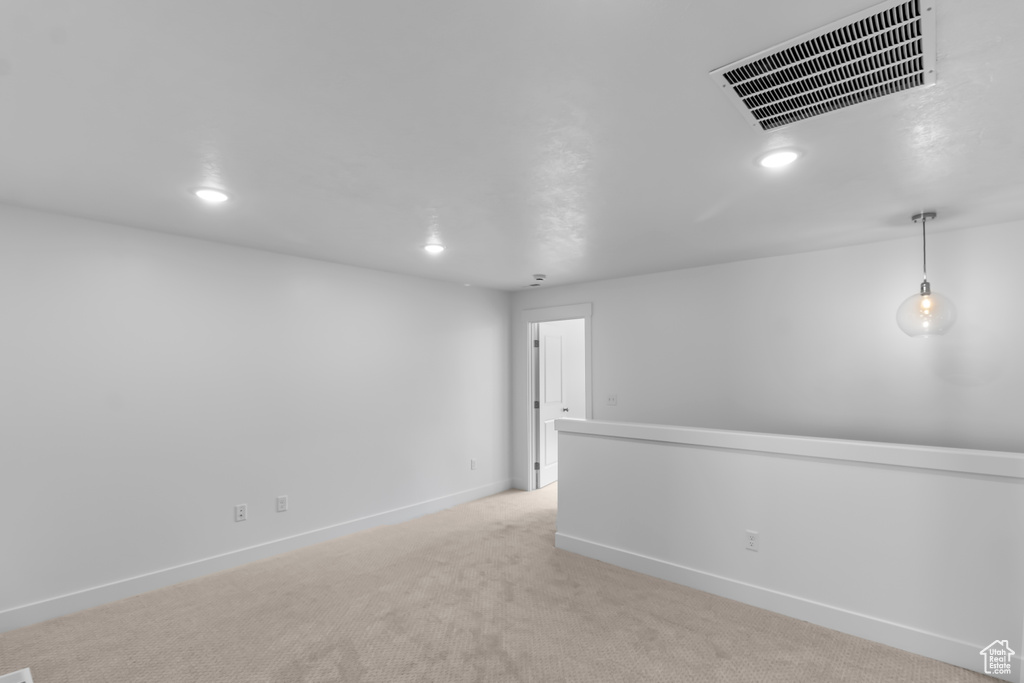 Spare room with recessed lighting, light carpet, and baseboards