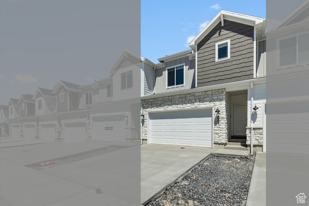 View of property featuring stone siding, board and batten siding, concrete driveway, an attached garage, and a residential view