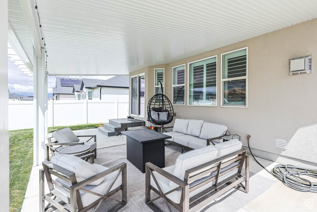 View of patio featuring outdoor lounge area and fence
