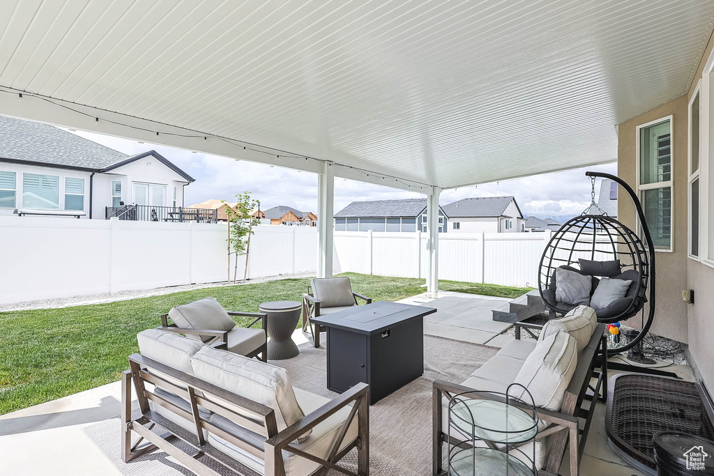 View of patio / terrace featuring an outdoor living space with a fire pit and a residential view