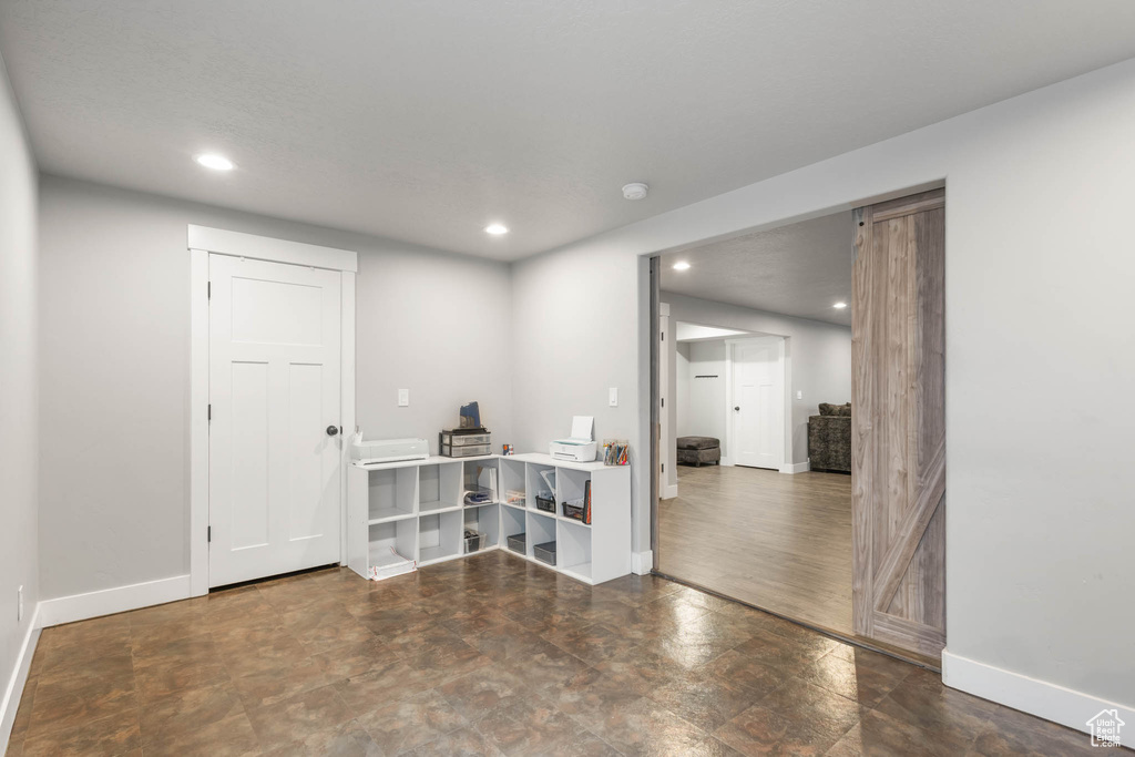 Empty room featuring recessed lighting, baseboards, and a smoke detector