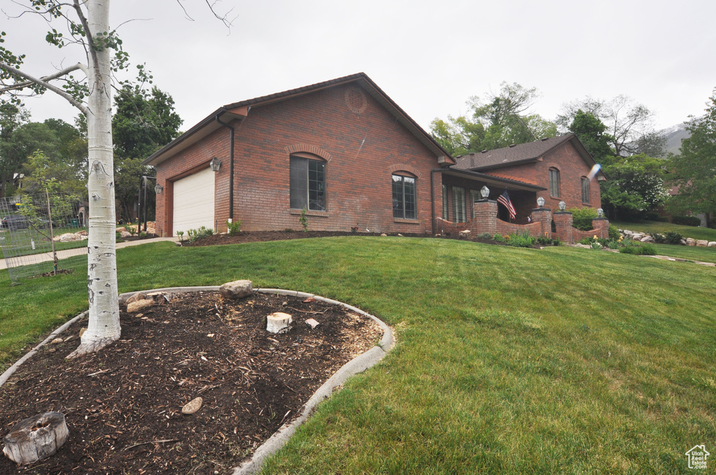 View of side of property with brick siding and an attached garage