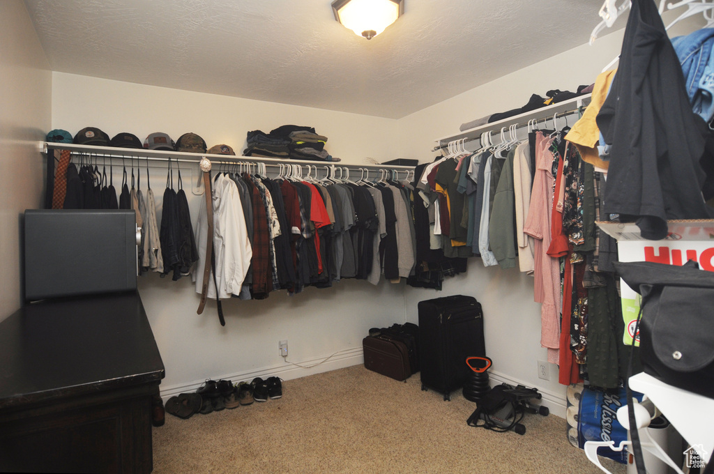 Walk in closet with carpet flooring