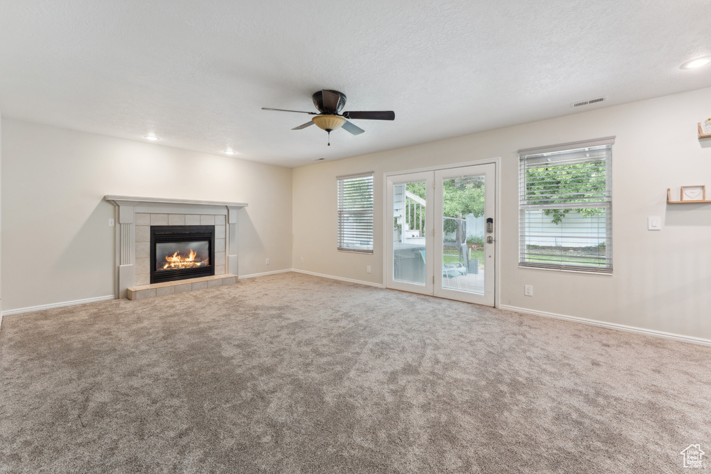 Unfurnished living room with a fireplace, a ceiling fan, carpet, baseboards, and recessed lighting