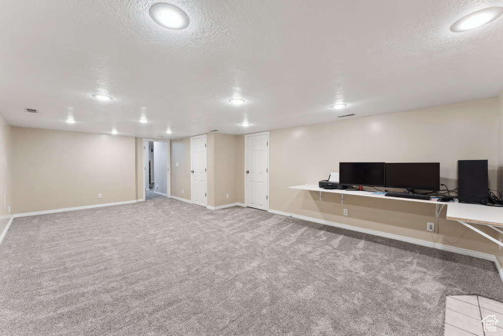 Unfurnished office featuring baseboards, carpet floors, recessed lighting, and a textured ceiling