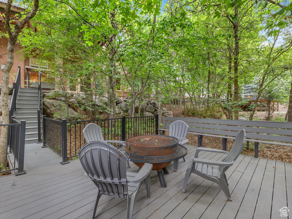 Wooden terrace with a fire pit and stairs