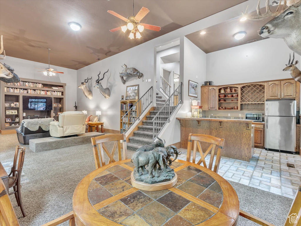 Dining area featuring a ceiling fan and stairway