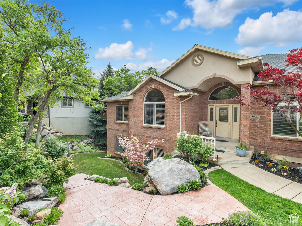 View of front of home with brick siding and stucco siding
