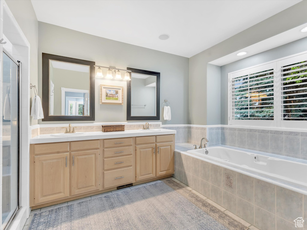 Full bath with a garden tub, a shower stall, and double vanity