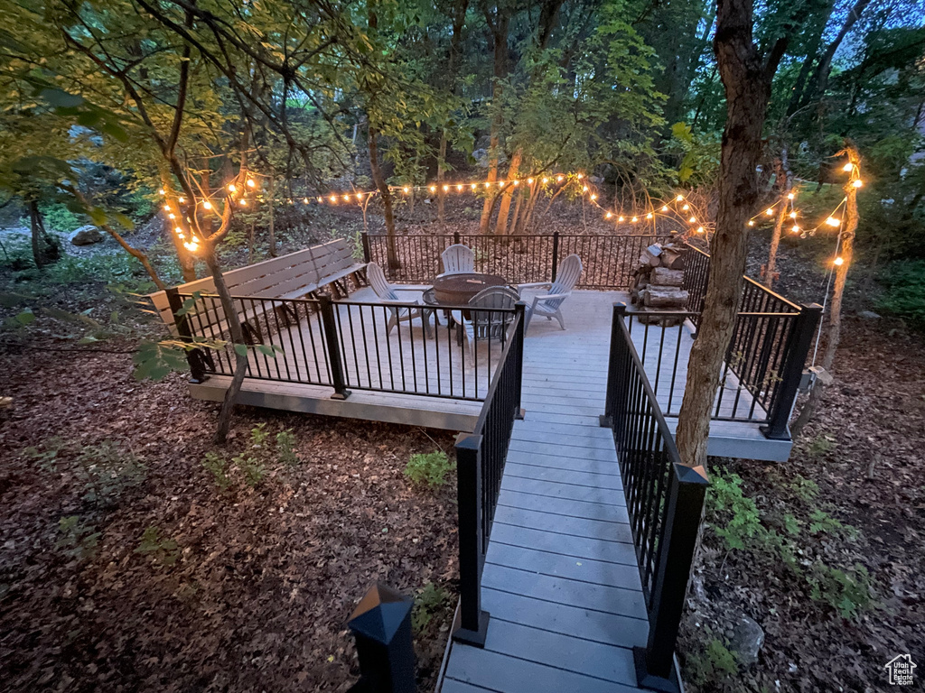 Wooden deck featuring an outdoor fire pit and stairs