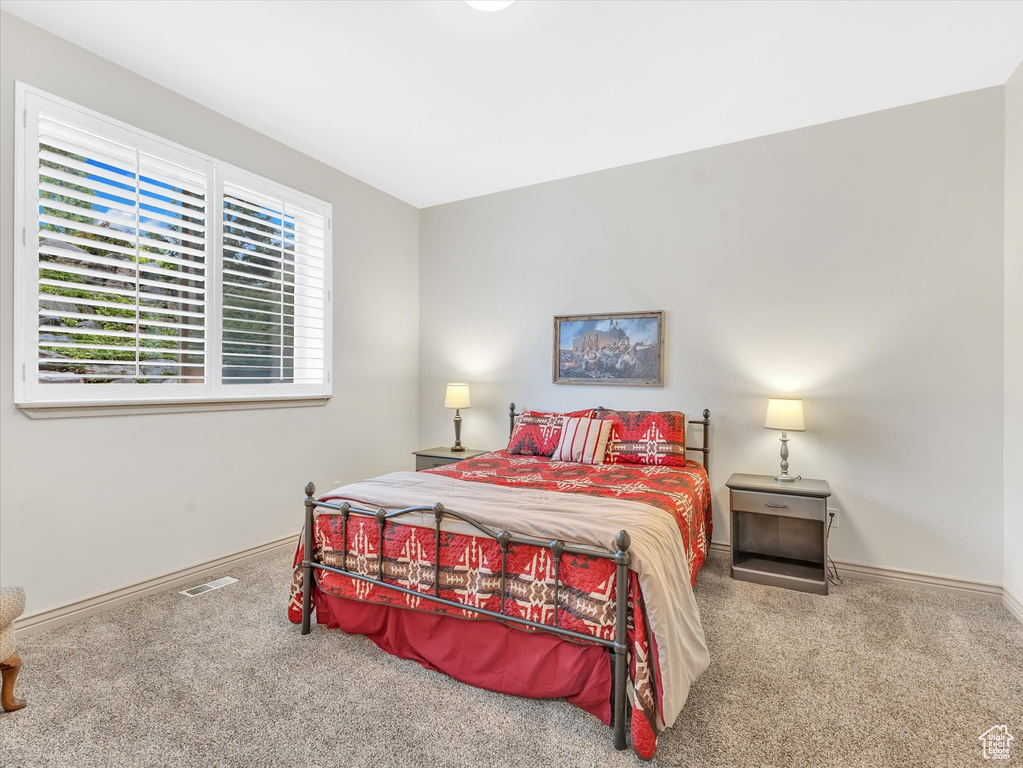 Bedroom featuring carpet flooring and baseboards