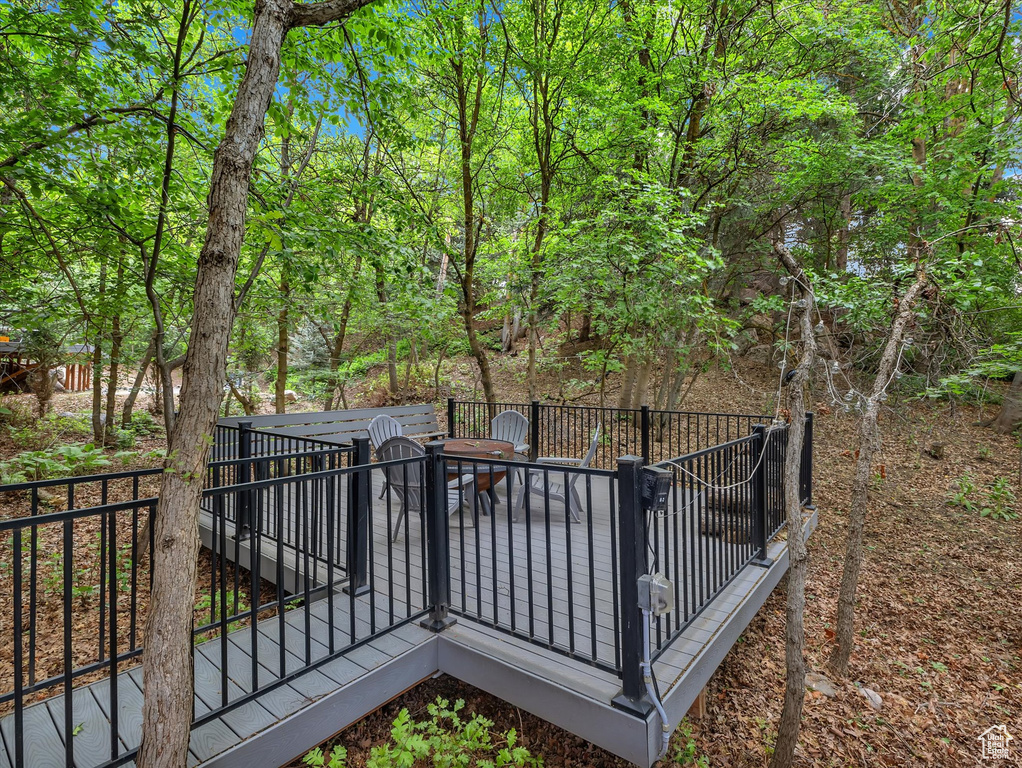 Wooden terrace featuring outdoor dining area