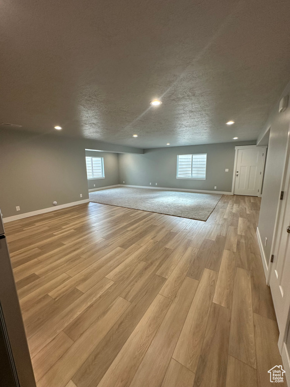 Below grade area featuring light wood-type flooring, recessed lighting, and baseboards