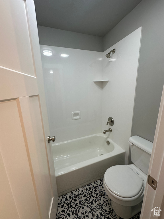 Full bathroom with toilet, tile patterned flooring, and bathtub / shower combination