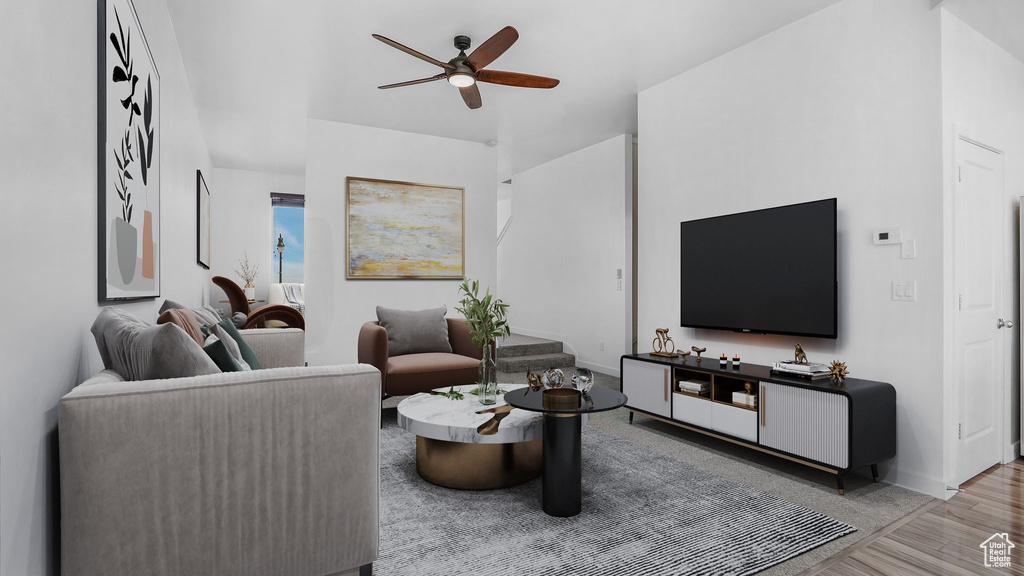 Living room featuring ceiling fan, baseboards, and wood finished floors