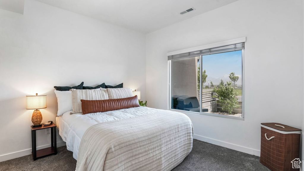 Carpeted bedroom featuring baseboards