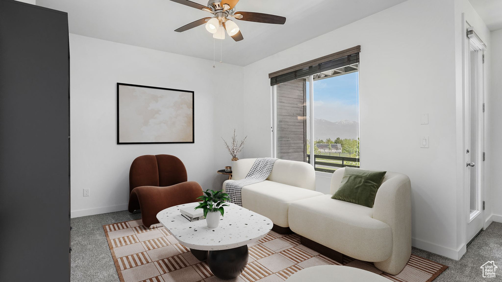 Living room featuring ceiling fan, carpet floors, and baseboards