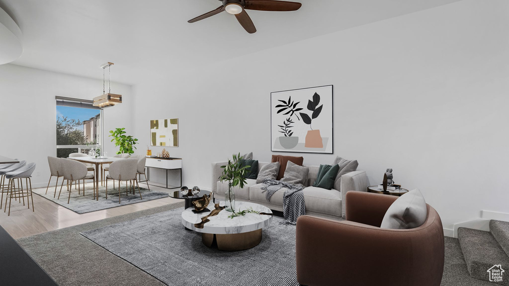 Living room featuring ceiling fan and wood finished floors