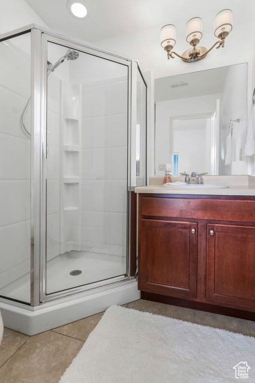 Full bath featuring tile patterned floors, a stall shower, and vanity