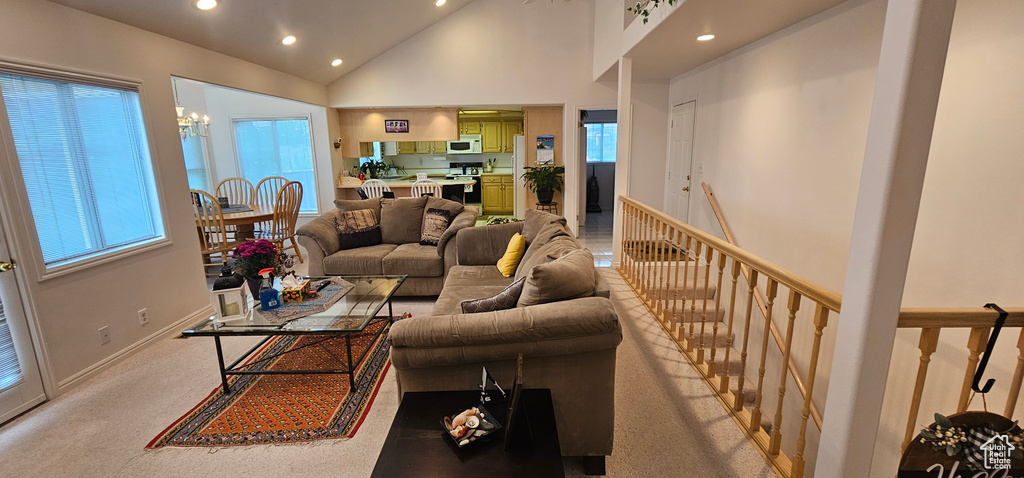 Living area with recessed lighting and high vaulted ceiling