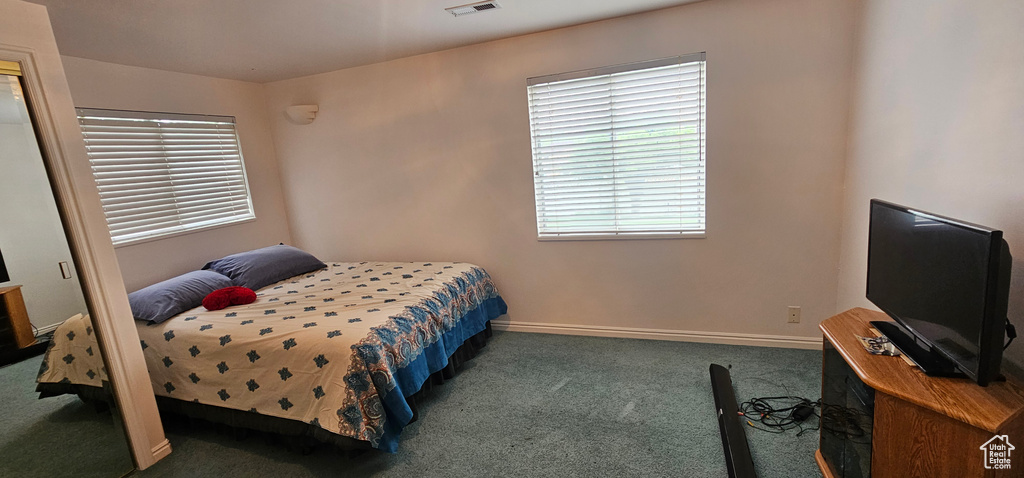 Carpeted bedroom featuring baseboards