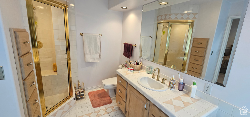 Full bath with a stall shower, tile patterned flooring, and vanity
