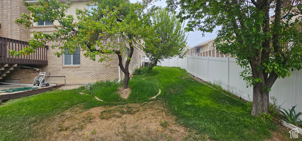 View of yard with a deck and stairway
