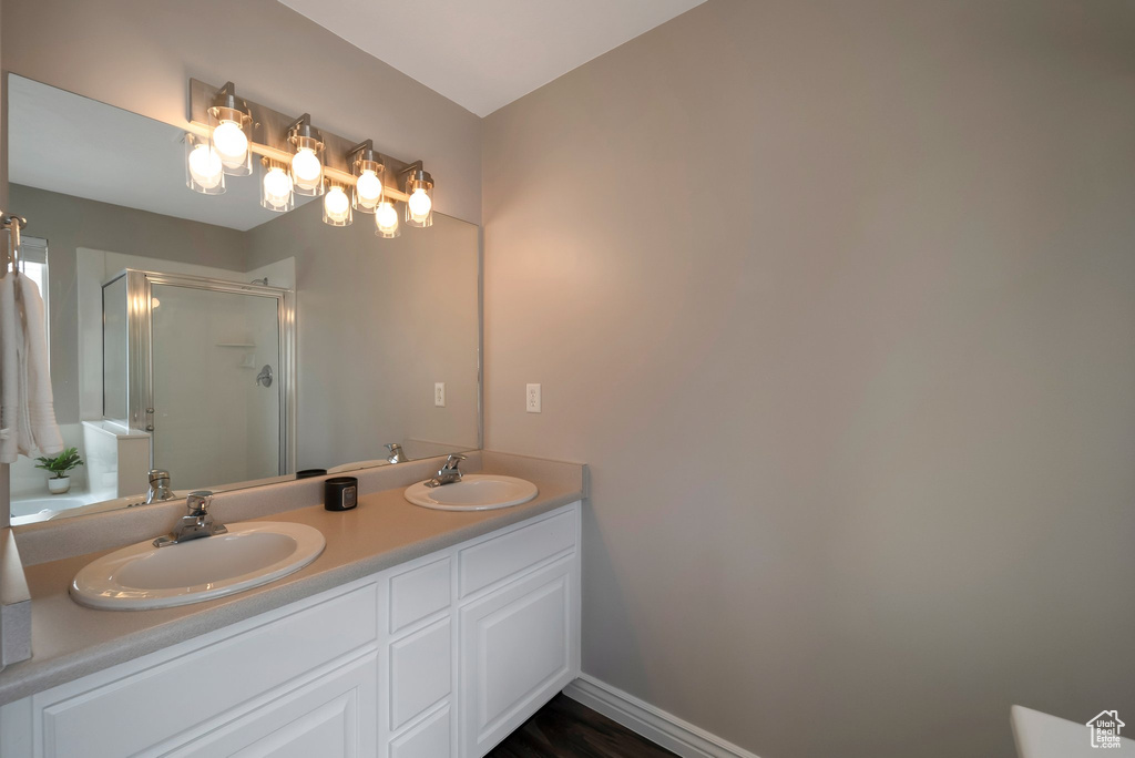 Bathroom with a shower stall and double vanity