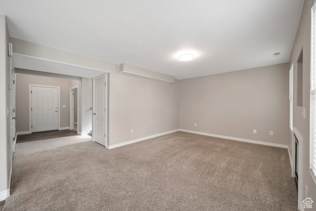 Carpeted spare room with baseboards
