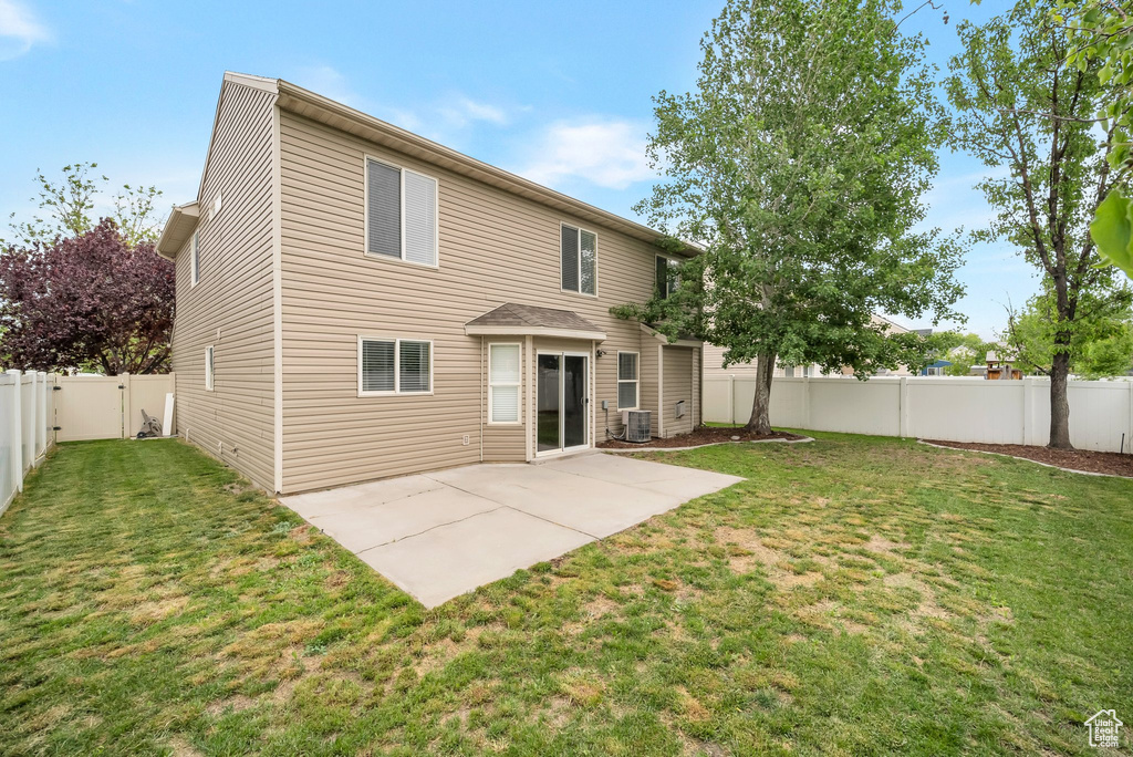 Back of property featuring cooling unit and a patio
