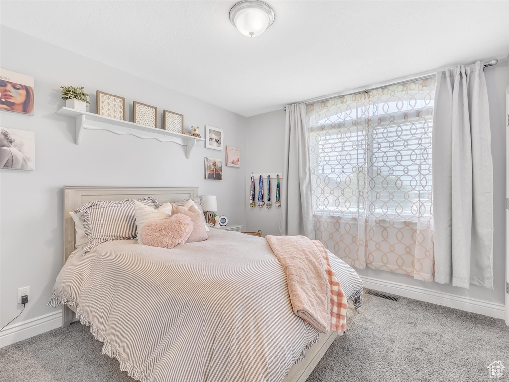Carpeted bedroom with baseboards
