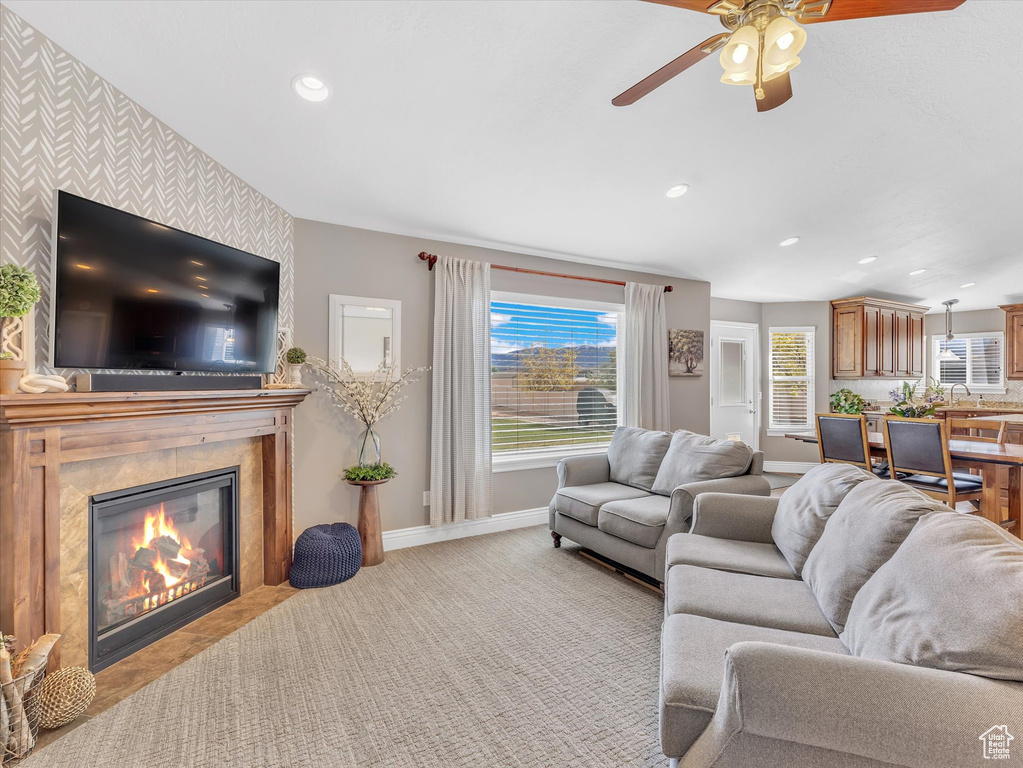 Living room featuring baseboards, recessed lighting, ceiling fan, a premium fireplace, and wallpapered walls