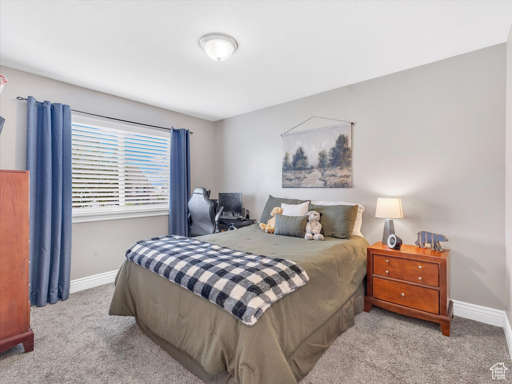 Carpeted bedroom with baseboards