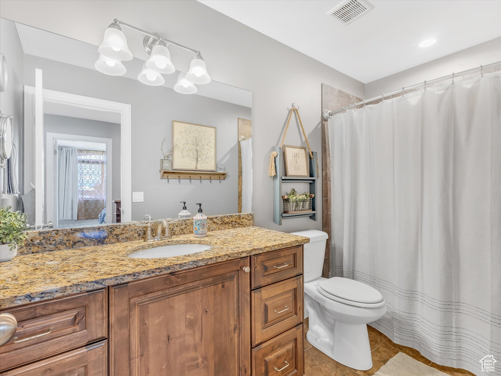 Bathroom with vanity, toilet, tile patterned floors, and a shower with curtain