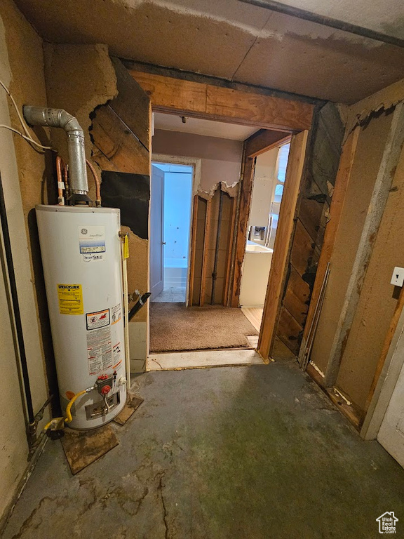 Below grade area featuring water heater