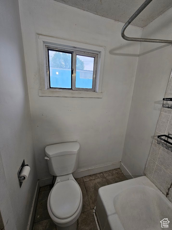 Bathroom featuring toilet and baseboards