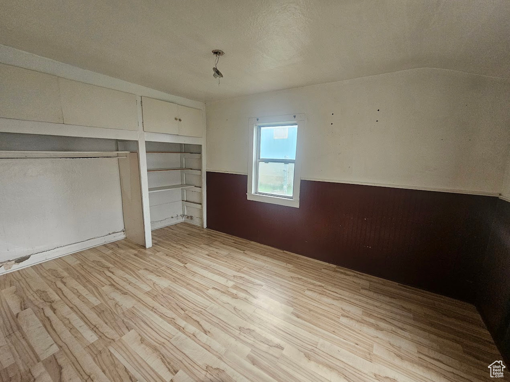 Unfurnished bedroom with light wood finished floors
