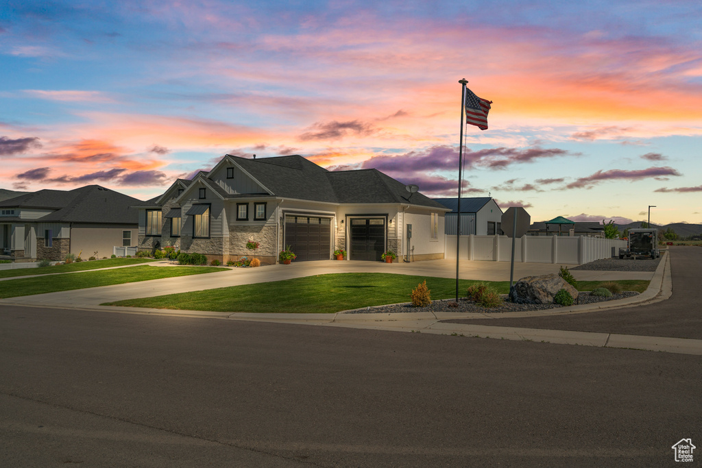 View of front of property featuring an attached garage and driveway