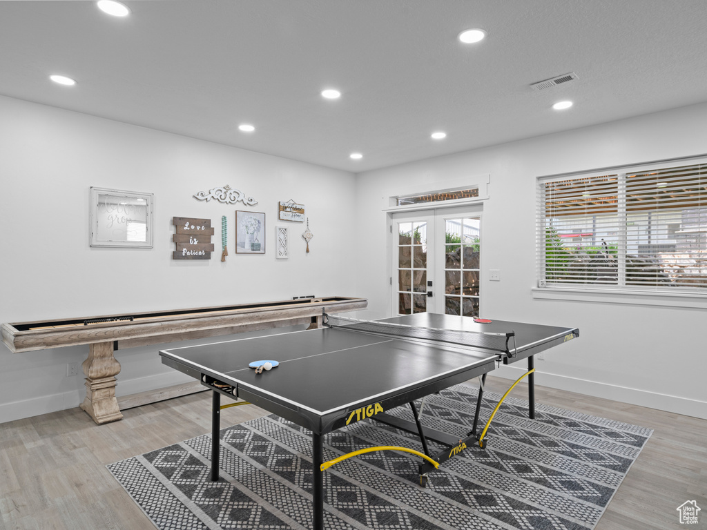 Game room featuring french doors, recessed lighting, baseboards, and light wood-style floors