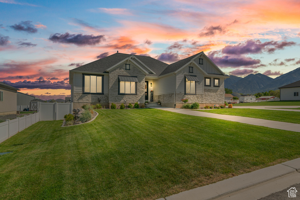View of front facade featuring stone siding, board and batten siding, and a mountain view