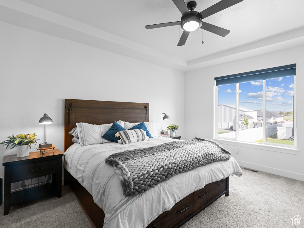 Carpeted bedroom with baseboards and a ceiling fan