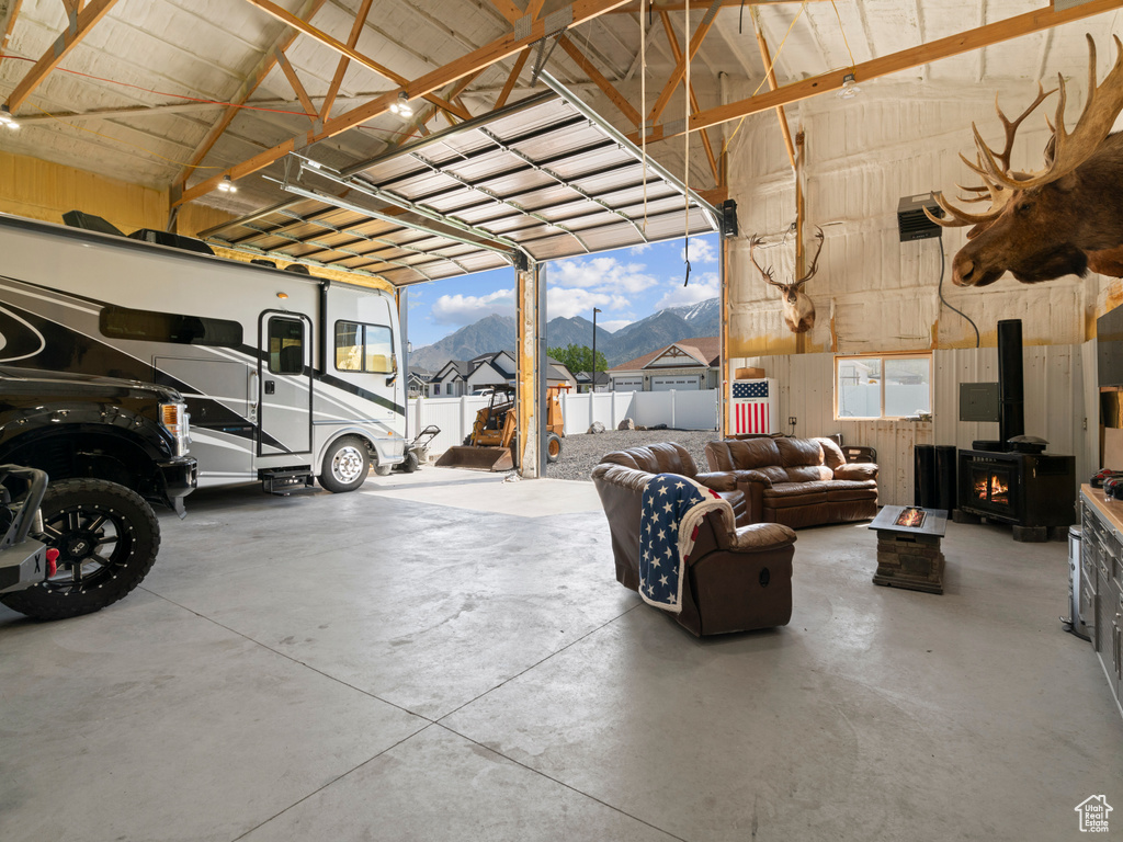 Garage featuring a wood stove and wooden walls