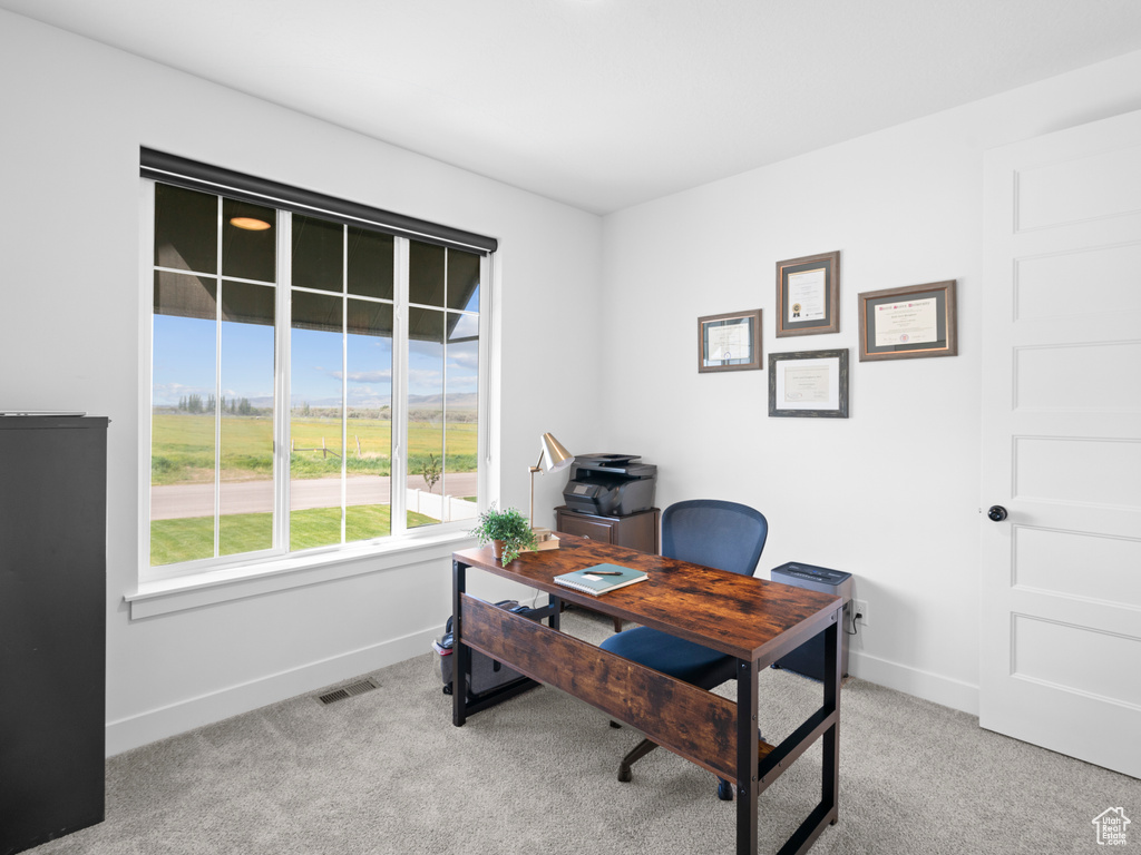 Office area featuring baseboards and carpet