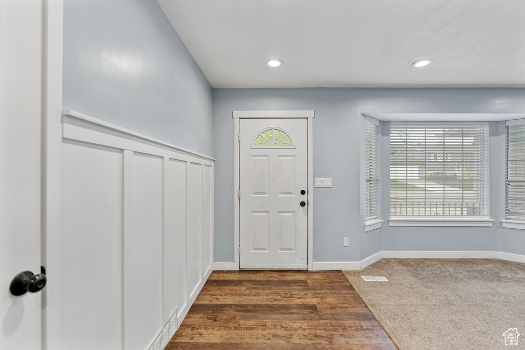 Entryway featuring dark carpet, recessed lighting, and baseboards